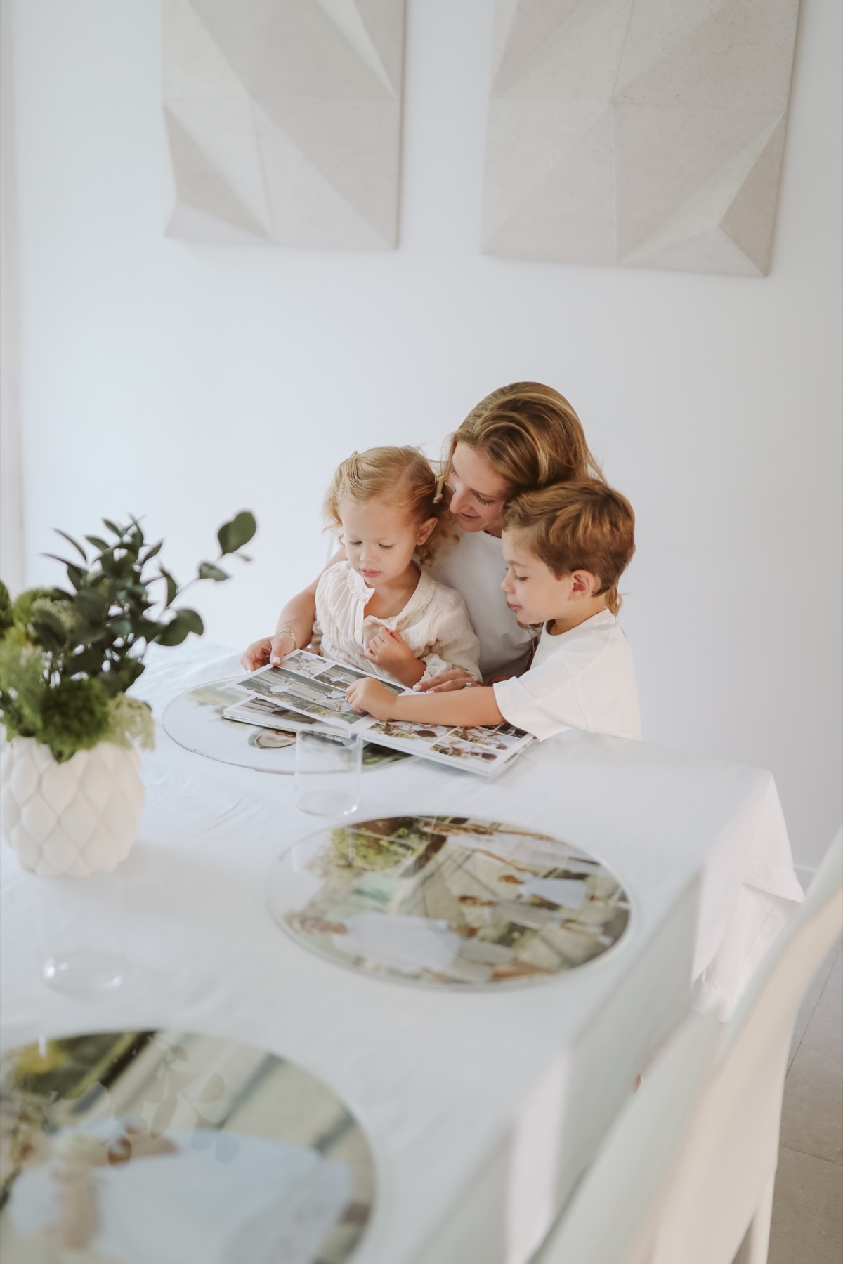 Veronica sharing a family photo book with her children